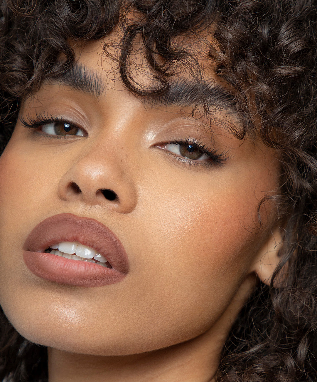 | desc:  Model wears Lip Sculpt in shade Fawn